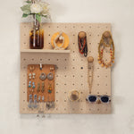 Small pegboard -styled with jewelry, sunglasses, a small shelf vase, and decorative objects. 